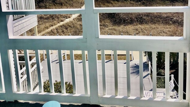 A beach view from a porch with a railing, a bench, and a pathway leading to the beach. - OCEANFRONT -  “Little piece of paradise” @ 206 Windsong in Windy Hill, N. Myrtle (North Myrtle Beach)