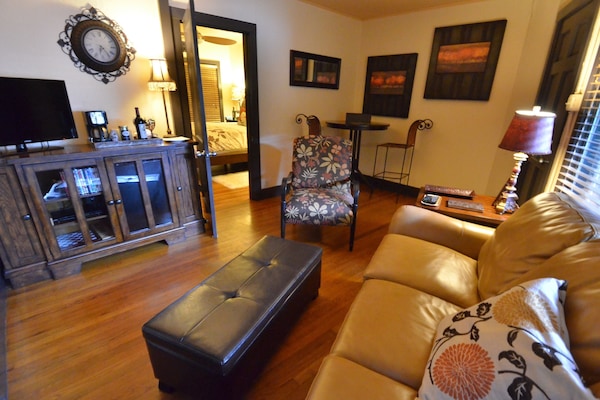 Living area includes leather sleeper sofa, mini fridge, DVD player and Wi-Fi