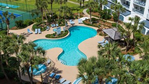 A resort with a large swimming pool, sun loungers, palm trees, and a tennis court. - Oh what a view - 711A !!!! (Gulf Shores)