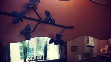 A room with a curved wall-mounted decoration featuring leaves and branches.