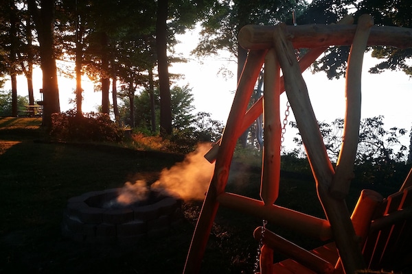 the campfire and log swing over looking the lake