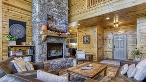A cozy log cabin interior with a stone fireplace, leather sofas, and wooden walls. - ✨ Chesnut Ridge, Beautiful Mountain Cabin in the Best Location 🏅  (Gatlinburg)