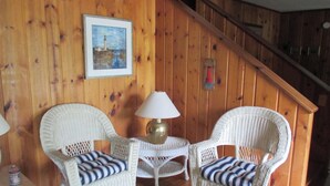A wooden interior with wicker chairs, a small table, and a lamp. - Only 1.5 Blocks To Ocean, 1-3 blocks of restaurants, shops, bars. Come enjoy! (Rehoboth Beach)