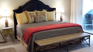 A bedroom with a bed, bedside lamps, a bench, and a ceiling fan. - Private End Of Street - Home In Lawton Woods (Hilton Head Island)