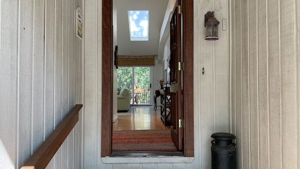 A wooden hallway with a door leading to a room with a view of the outdoors. - Private End Of Street - Home In Lawton Woods (Hilton Head Island)