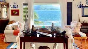 A cozy living room with a view of the ocean, a wooden ceiling, and a chandelier. - St Kitts Two for One Luxury Villa & Private Lounge on beach breathtaking views! (South East Peninsula)