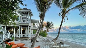 A beachside property with a covered patio, lounge chairs, and a view of the ocean. - St Kitts Two for One Luxury Villa & Private Lounge on beach breathtaking views! (South East Peninsula)