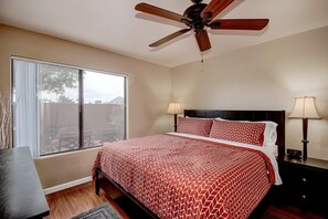 A bedroom with a bed, two bedside lamps, a ceiling fan, and a window with blinds. - ON GOLF COURSE & Camelback Mtn Views, Spring Training & Shopping (Scottsdale)