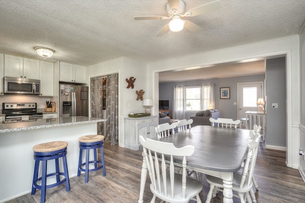 Enter through the porch into dining/kitchen area