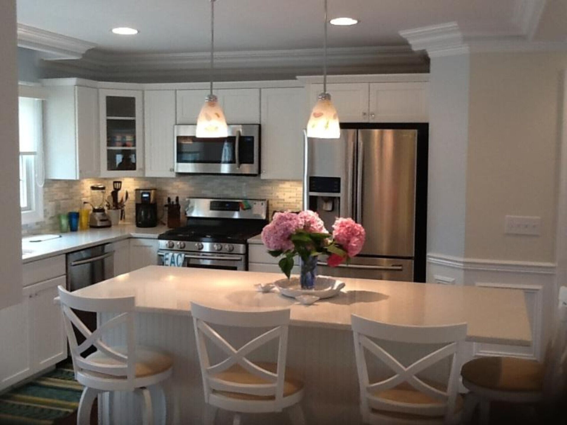 Kitchen with led lighting, island and stainless appliances
