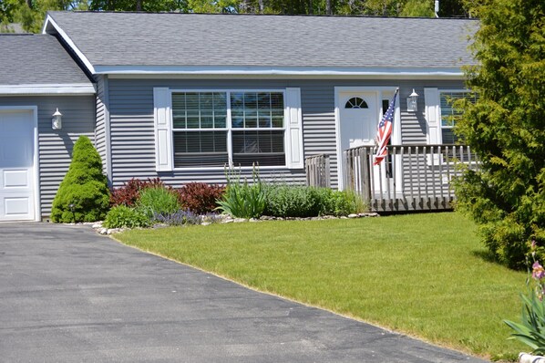 A single-story house with a grey exterior, white trim, and a front porch. - Beautiful Home in Baileys Harbor (Baileys Harbor)
