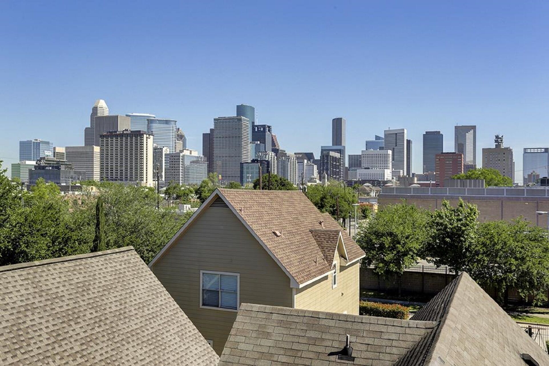 A residential area with a city skyline in the background.