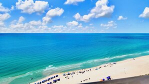 A beach with clear blue water and a sandy shore. - The Oasis 2010 | Spacious, Lazy River, Poolside Grill, New Splash Pad, Pool with Slide! (Orange Beach)