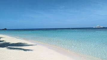 On the beach, sun loungers, beach towels