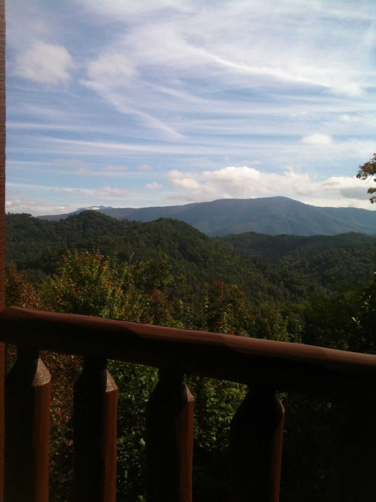 A balcony with a view of a mountainous landscape.
