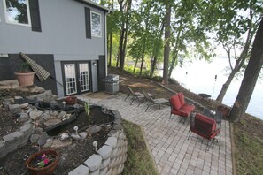 A patio with a grill, outdoor seating, and a view of a lake. - Lake Front, huge views minutes from Mooresville NC (Catawba)