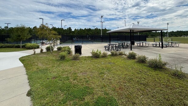 A park with picnic tables, a covered seating area, and a sports field. - Nestled near beach-new updates-community pool-near shops, restaurants & cafes. (Santa Rosa Beach)