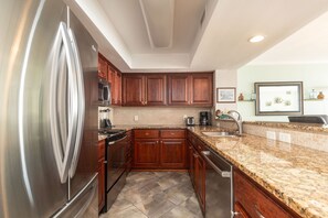 Fridge, dishwasher, coffee/tea maker, cookware/dishes/utensils