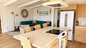 A modern kitchen with a central island, wooden cabinets, and a built-in oven. - Best Spot in Carlsbad! Private Yard, Ocean View, Walk to beach.  (Carlsbad)