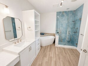 A modern bathroom with a freestanding bathtub, a large mirror, and a walk-in shower with blue tiles. - BLUE DOLPHIN PENTHOUSE LUXURY 3 BDR 3 BA 2026 Booking Fast (Fort Walton Beach)