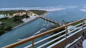 A coastal hotel with a pool, beach access, and a view of the ocean.
