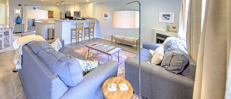A modern living room with a sofa, a coffee table, and a lamp.