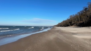 Een strand met een heldere lucht en rustige zee.