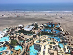 A water park with multiple slides and pools, surrounded by a sandy beach and the ocean. - Beautiful FAMILY Condo Steps From Beach & Boardwalk. No prom/graduation parties. (Wildwood)