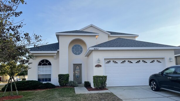 A single-story house with a garage, a front door, and a mailbox. - S-Facing Pool, 3.6 mi from Disney, man-gated resort, wheelchair accessible (Kissimmee)