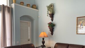 A living room with a brown leather sofa set, a coffee table, and a lamp. - S-Facing Pool, 3.6 mi from Disney, man-gated resort, wheelchair accessible (Kissimmee)