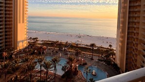 A resort with a pool, beach, and ocean view.