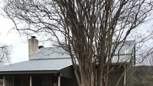 A house with a covered porch, a large tree, and a bird bath. - ACE OF HEARTS The perfect getaway! Only 3.5 miles from Main Street. (Fredericksburg)