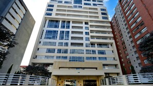 A multi-story building with a central entrance, large windows, and a sign reading "aldrovandi". - BEAUT on Ave Gonzalez Suarez, GRT LOC, WiFi, Pool, JacuZ, SAU, Gym, PKG, Promos. (Quito Canton)