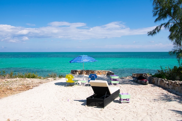 Sun yourself on our beautiful sand terrace. Use the stairs to enter the ocean.
