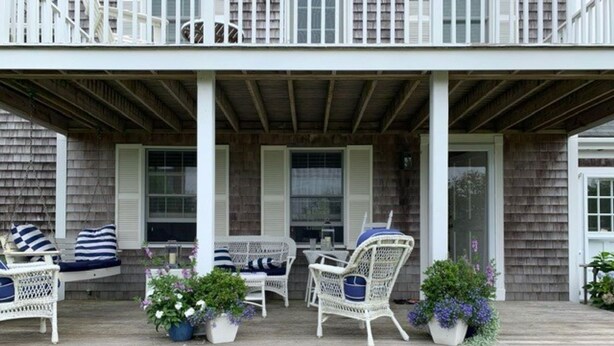 A covered porch with wicker furniture and potted plants. - Family Friendly Island Getaway (Nantucket)