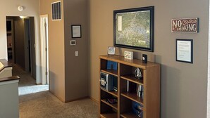 A living room with a television, a bookshelf, and a 'No Smoking' sign. - Branson area Lakehouse, 5 Bedrooms, 3 Baths, (Sleeps 9-15) New decks Spring 2019 (Kimberling City)