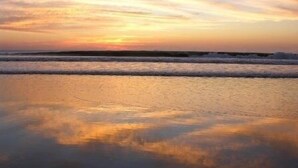 A beach with waves and a sunset. - 4 bed / 4 bath w pool and rooftop patio 50m from Beach in Grande (playa grande)