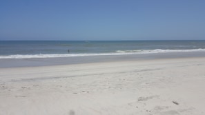 Enjoy a serene beach experience with calm ocean waters and soft sand.