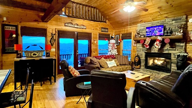 A cozy log cabin interior with a fireplace, wooden walls, and a television. - July4-7OPEN50%OFF❤️BESTMountainView/Hot Tub/ Pool Table  /Ping Pong Table/ Wifi  (Blue Ridge)
