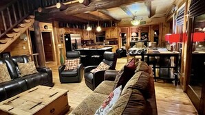 A cozy cabin interior with a living area featuring a sofa, chairs, and a wooden coffee table. - July4-7OPEN50%OFF❤️BESTMountainView/Hot Tub/ Pool Table  /Ping Pong Table/ Wifi  (Blue Ridge)