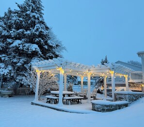 A snow-covered outdoor area with a gazebo, picnic tables, and string lights. - AnJ Bed and Breakfast, family friendly, quiet country setting.  (New Holland)