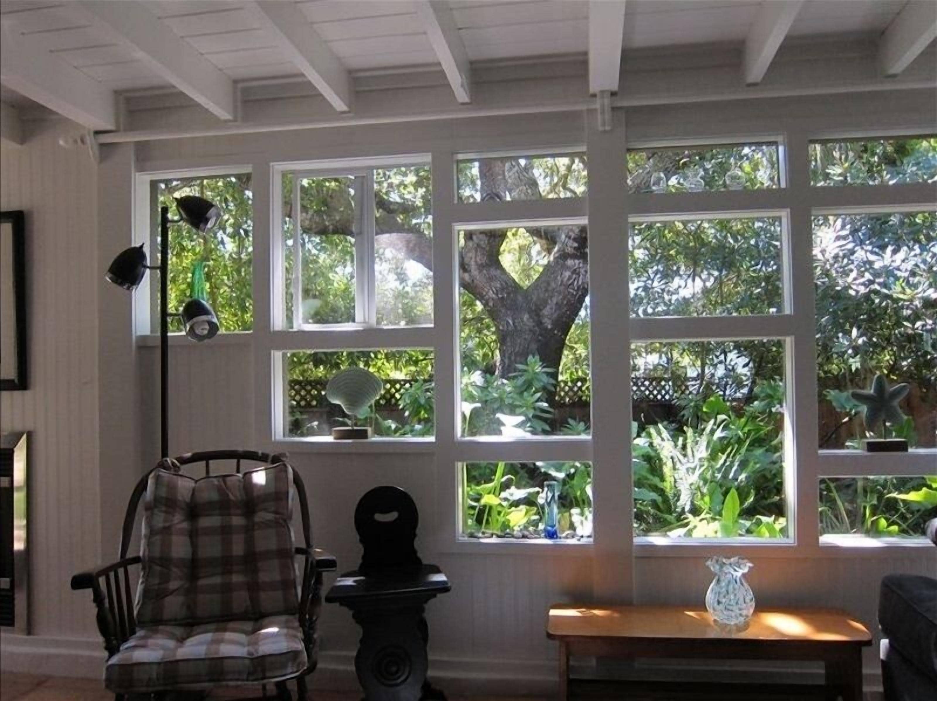 One of the most unique windows ever, looks out on the green garden and oak tree