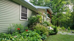 A house with a covered porch and a well-maintained garden.