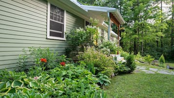 A house with a covered porch and a well-maintained garden.