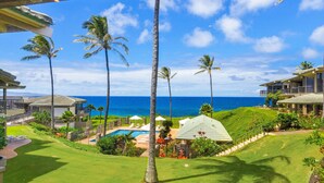 A resort with a pool, palm trees, and a view of the ocean. - REDUCED July & August!  ~ OCEAN FRONT Bay Villa- 25 G-5 ~ Platinum Maui Vacations (Lahaina)