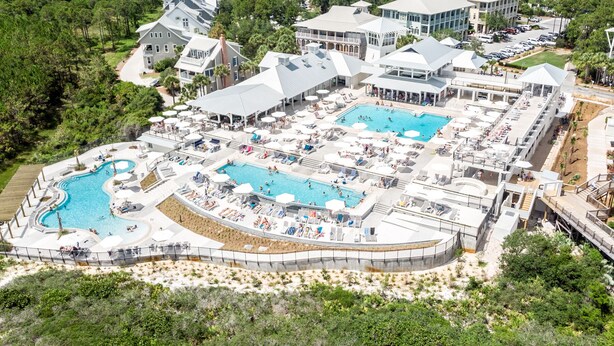 An aerial view of a resort with multiple swimming pools, sun loungers, and a landscaped area with trees. - Blissful days, barefoot nights at Beach Bliss / Private Pool / Gulf Front Beach Club / 6 Bikes (Santa Rosa Beach)