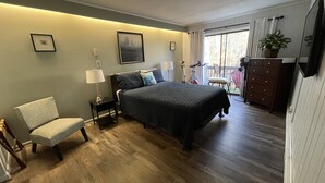 A bedroom with a bed, a chair, a dresser, a lamp, and a window with curtains. - BEECH MOUNTAIN HIGH - WALK TO SLOPES! (Beech Mountain, NC)