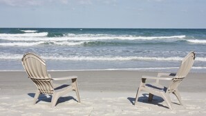 Two beach chairs facing the ocean with waves crashing onto the shore. - Large Oceanfront 2BD/2BA, Sleeps 6, Pool, Kitchen, W/D, Parking, Ormond/Daytona (Ormond Beach)