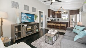 A modern living room with a television, sofa, and coffee table.