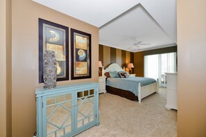 A bedroom with a bed, nightstands, a dresser, and artwork on the wall. - Beautiful Condo, Close to the Beach and Plenty of Room for Your Family! (Ocean City)
